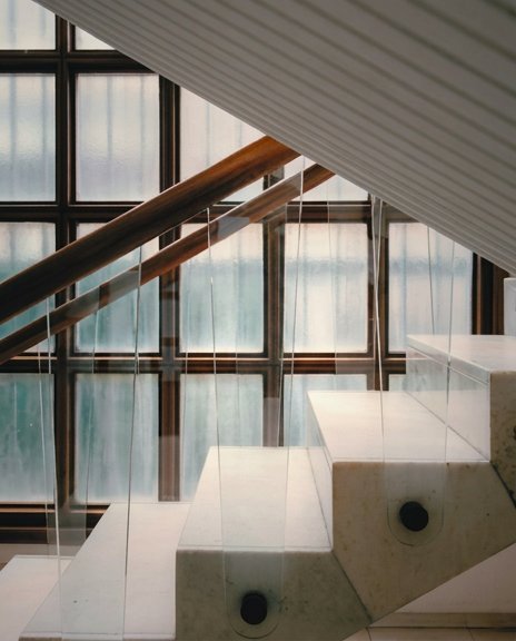 Architectural detail — glass treads, polished concrete, light-shadow tension.